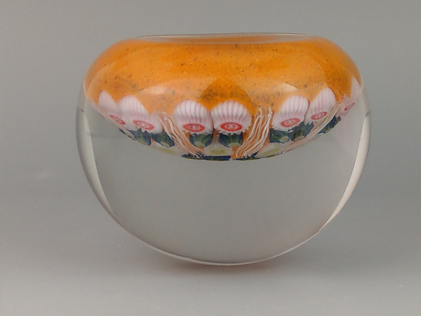 Strathearn Paperweight 7 Spoke Cartwheel Millefiori latticino orange background