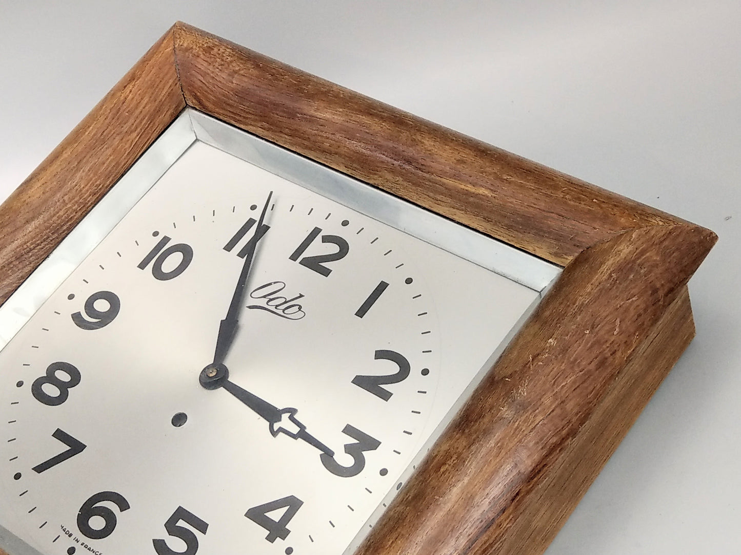 Large Wall Clock by Odo, Art Deco, in a Square Wooden Frame with a Silver Dial and Black Hands
