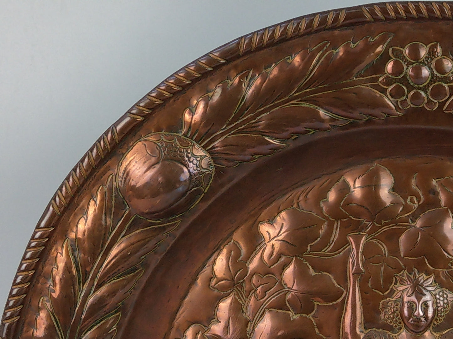 Large arts and crafts copper plaque Bacchus on the barrel with poppies wreath c.1900