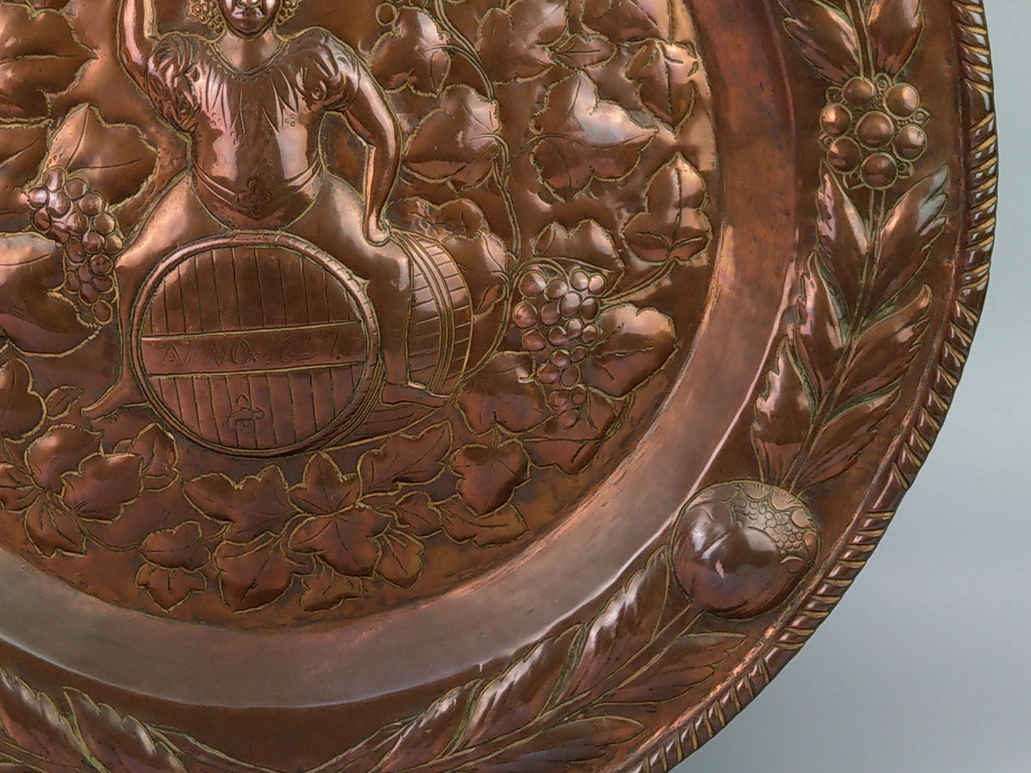 Large arts and crafts copper plaque Bacchus on the barrel with poppies wreath c.1900