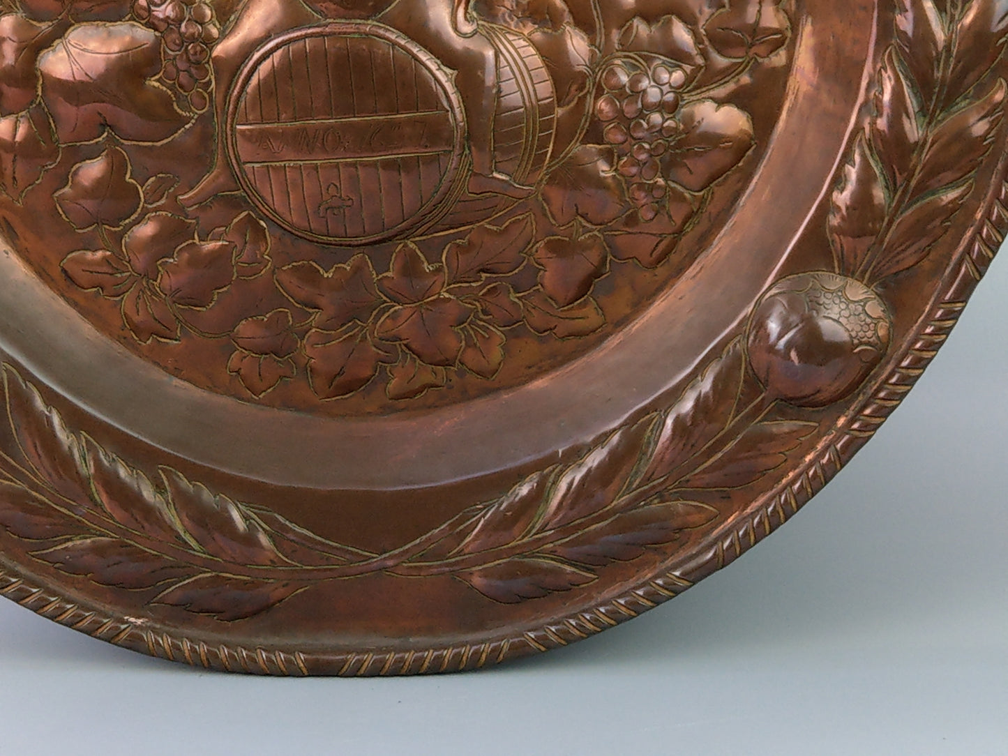 Large arts and crafts copper plaque Bacchus on the barrel with poppies wreath c.1900