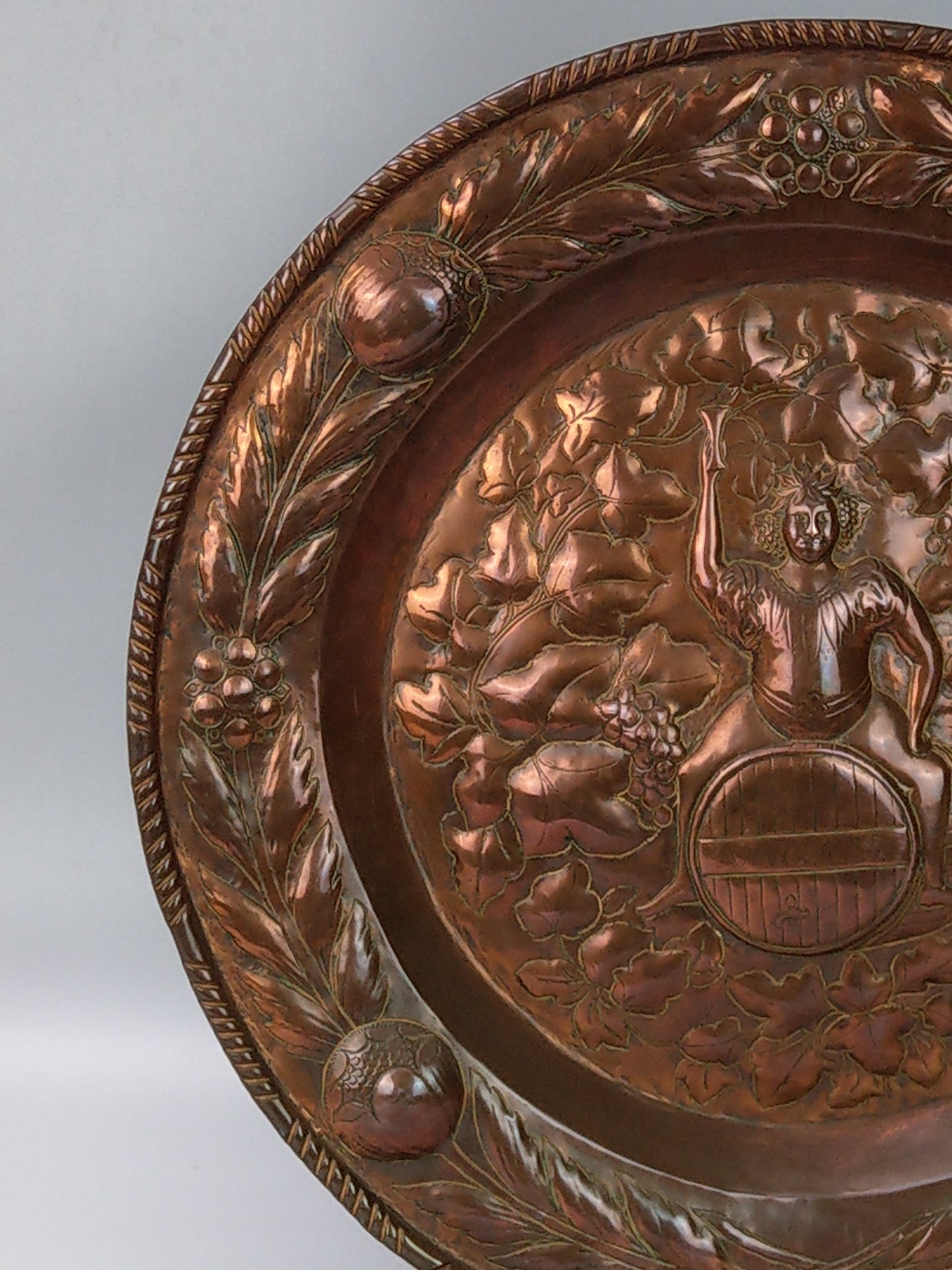 Large arts and crafts copper plaque Bacchus on the barrel with poppies wreath c.1900