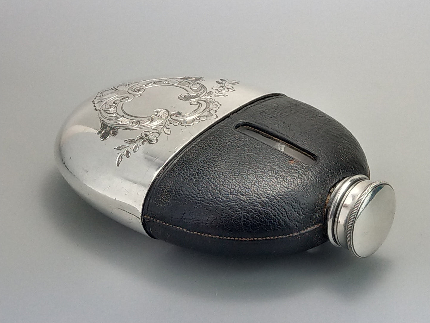 Antique Oval Hip Flask with cup leather covered by James Dixon