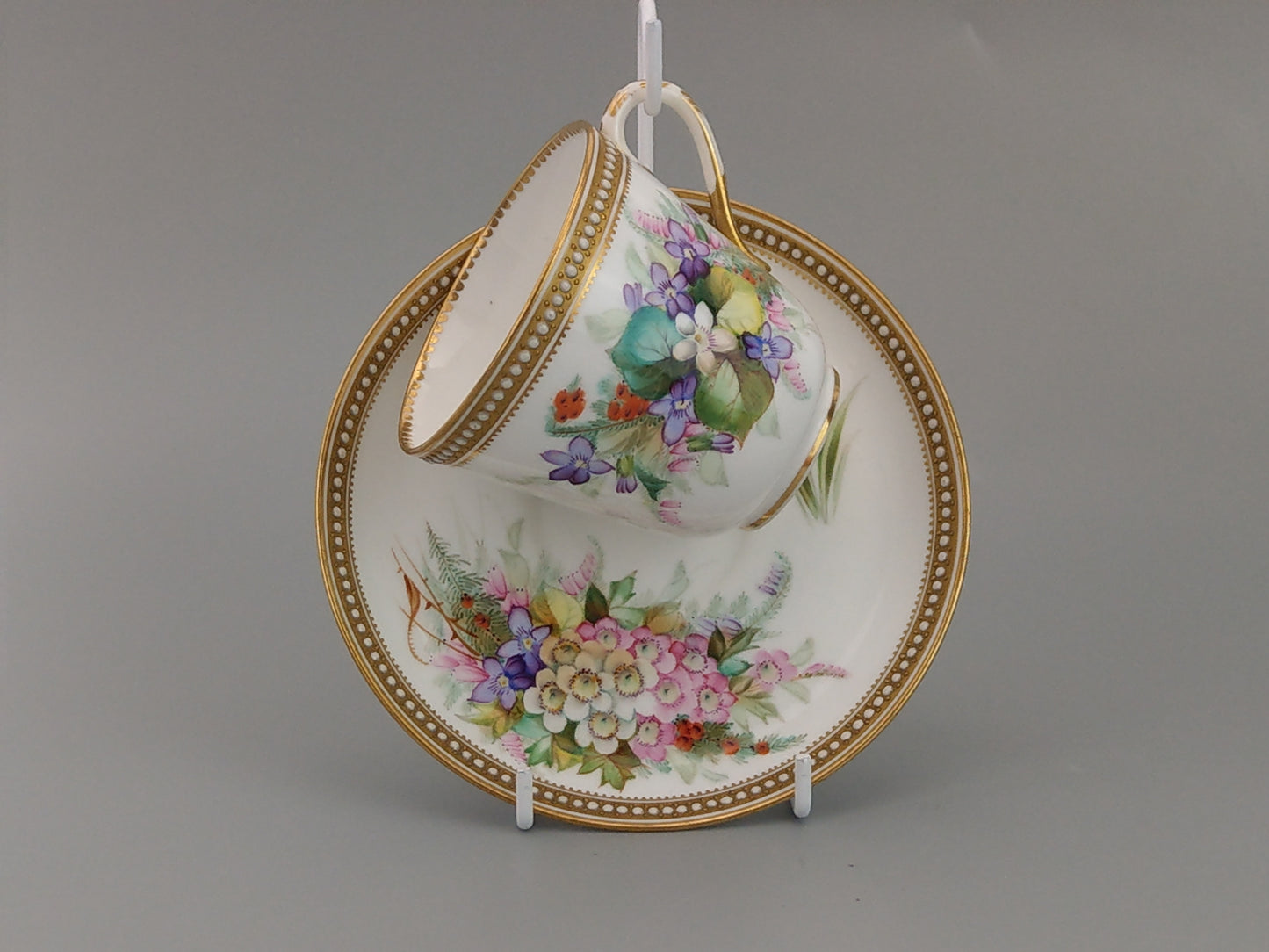 Royal Worcester tea cup and saucer, floral with jewelled borders, initials WY, c.1879