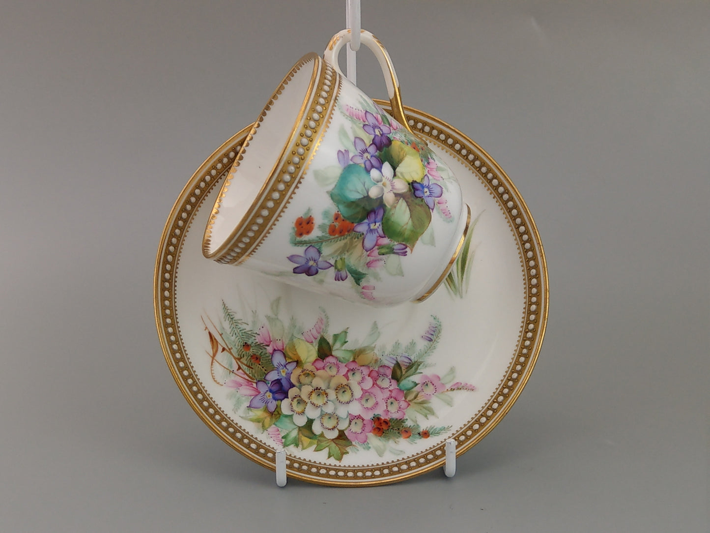 Royal Worcester tea cup and saucer, floral with jewelled borders, initials WY, c.1879