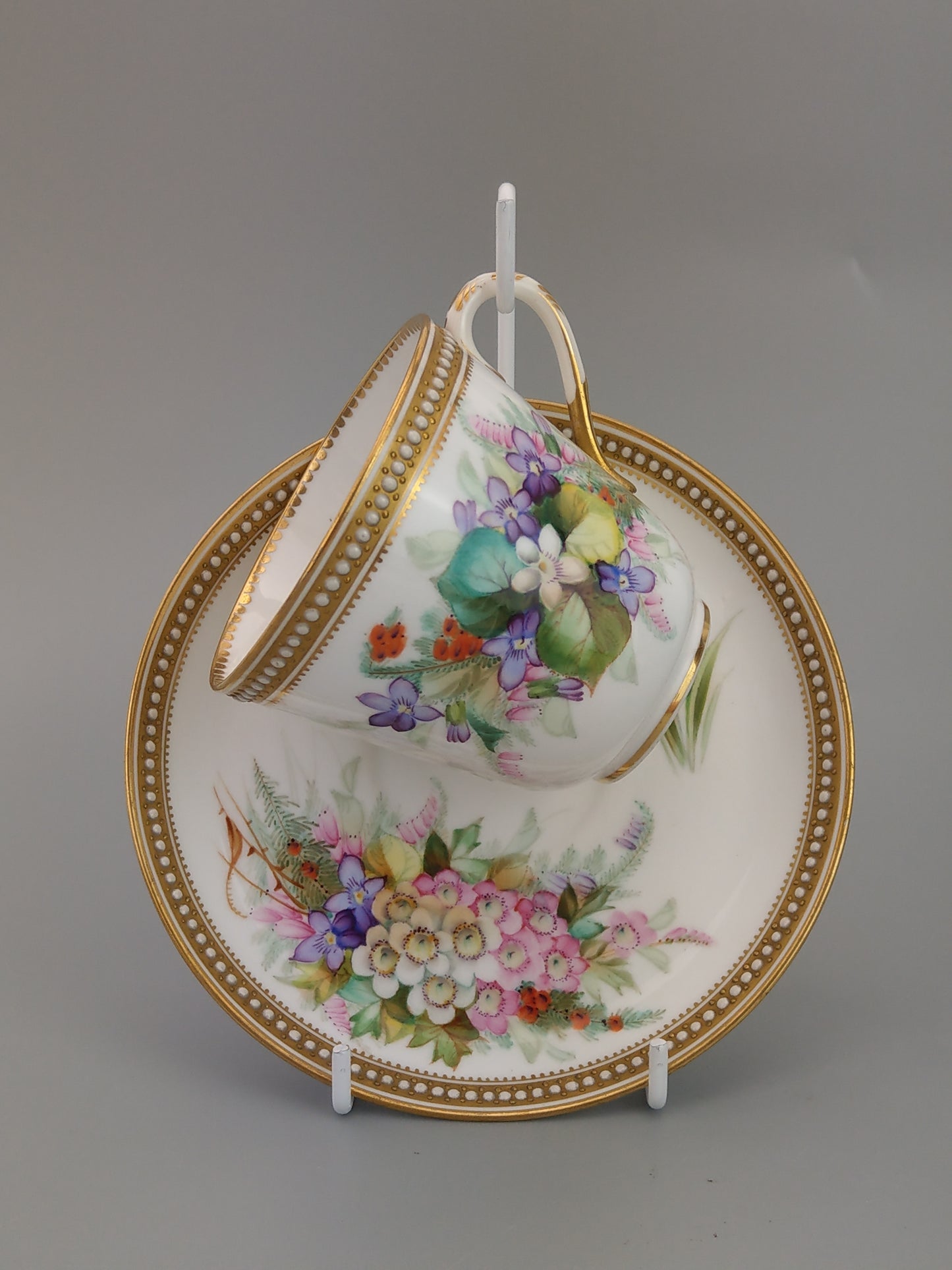 Royal Worcester tea cup and saucer, floral with jewelled borders, initials WY, c.1879