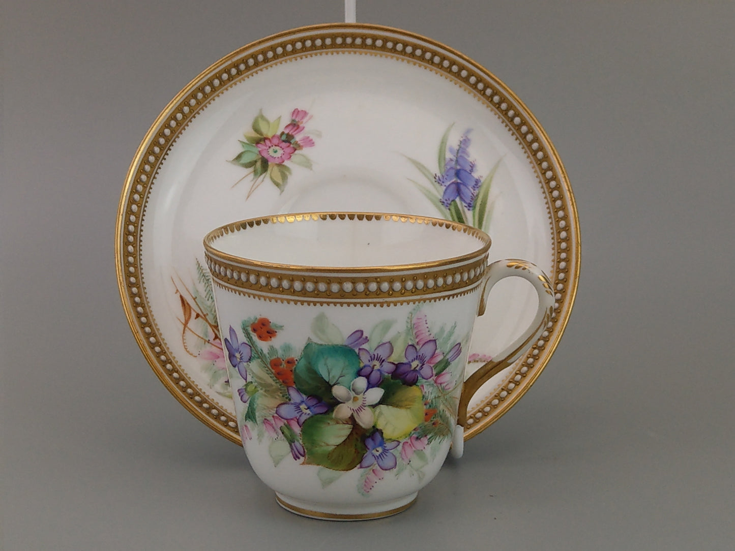 Royal Worcester tea cup and saucer, floral with jewelled borders, initials WY, c.1879