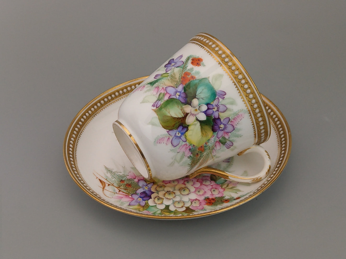 Royal Worcester tea cup and saucer, floral with jewelled borders, initials WY, c.1879