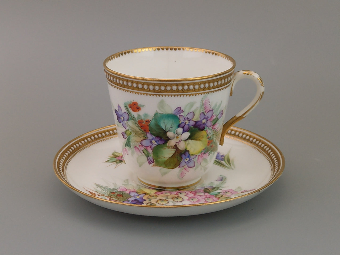 Royal Worcester tea cup and saucer, floral with jewelled borders, initials WY, c.1879