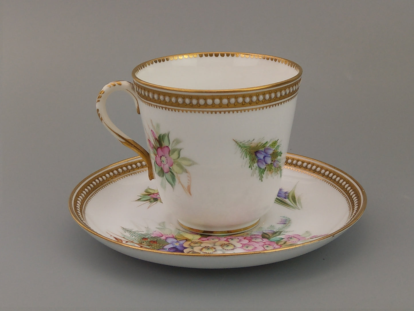 Royal Worcester tea cup and saucer, floral with jewelled borders, initials WY, c.1879