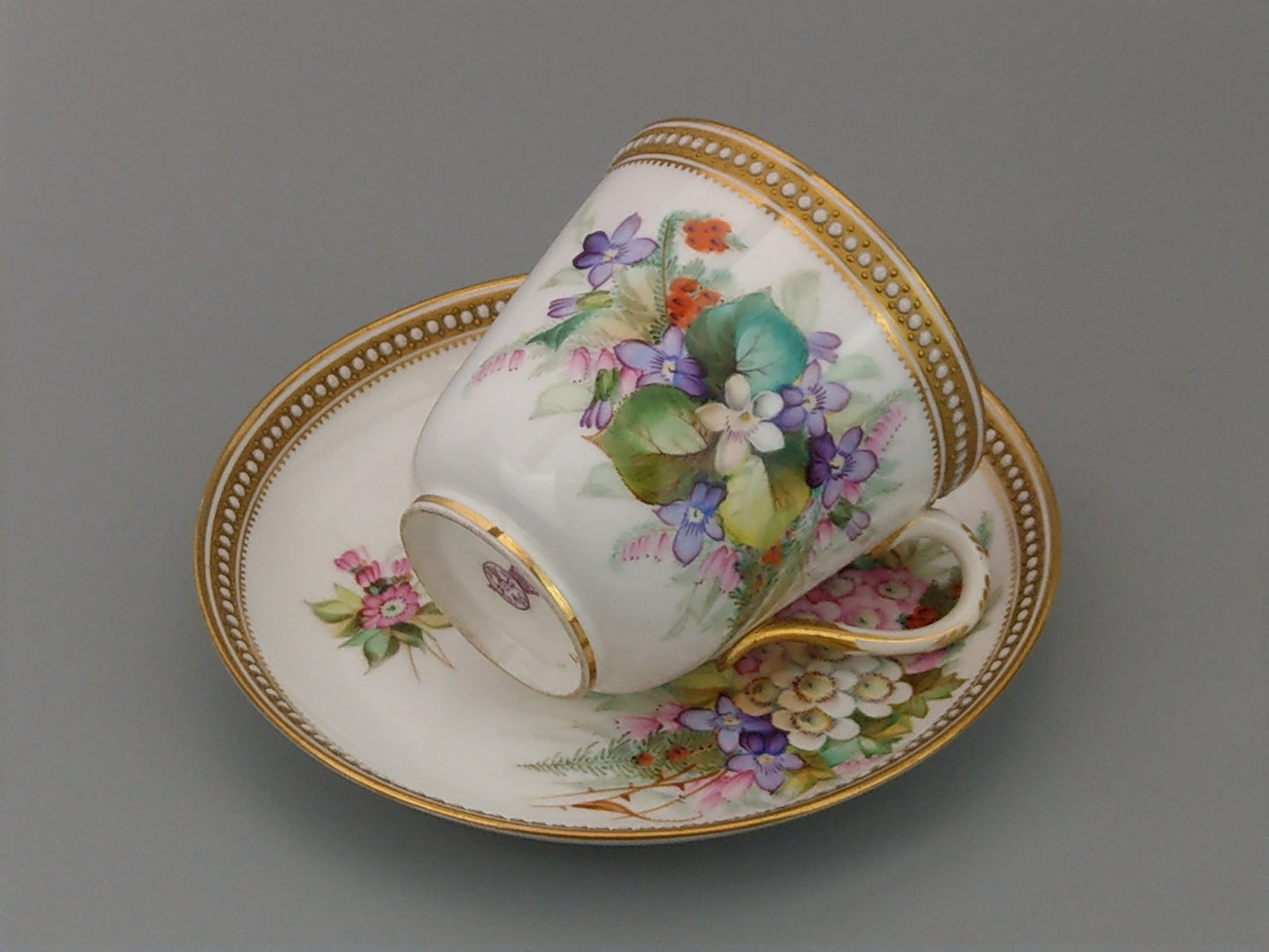 Royal Worcester tea cup and saucer, floral with jewelled borders, initials WY, c.1879