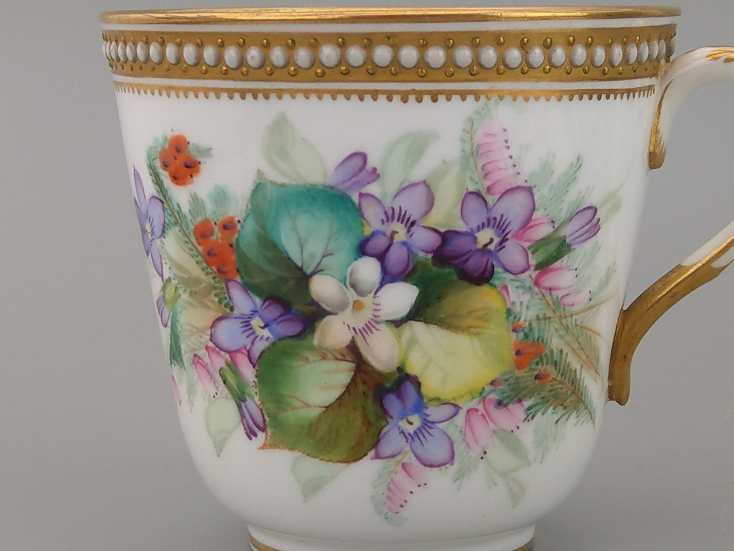 Royal Worcester tea cup and saucer, floral with jewelled borders, initials WY, c.1879