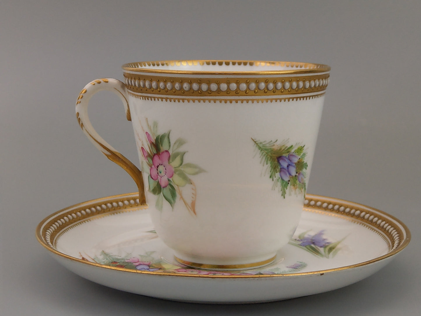 Royal Worcester tea cup and saucer, floral with jewelled borders, initials WY, c.1879