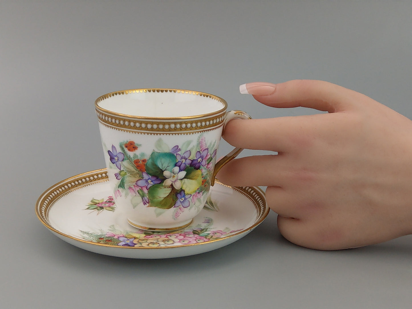 Royal Worcester tea cup and saucer, floral with jewelled borders, initials WY, c.1879