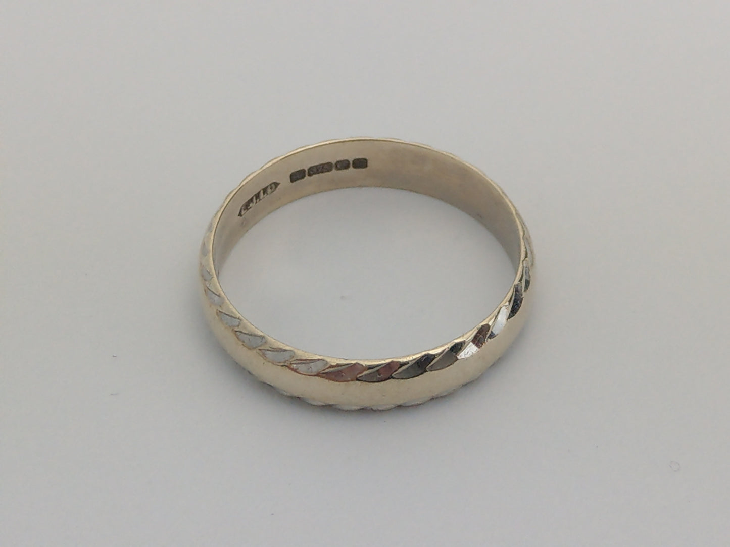 White 9ct Gold Simple Band Ring With Hammered Edge by Excalibur Jewellery