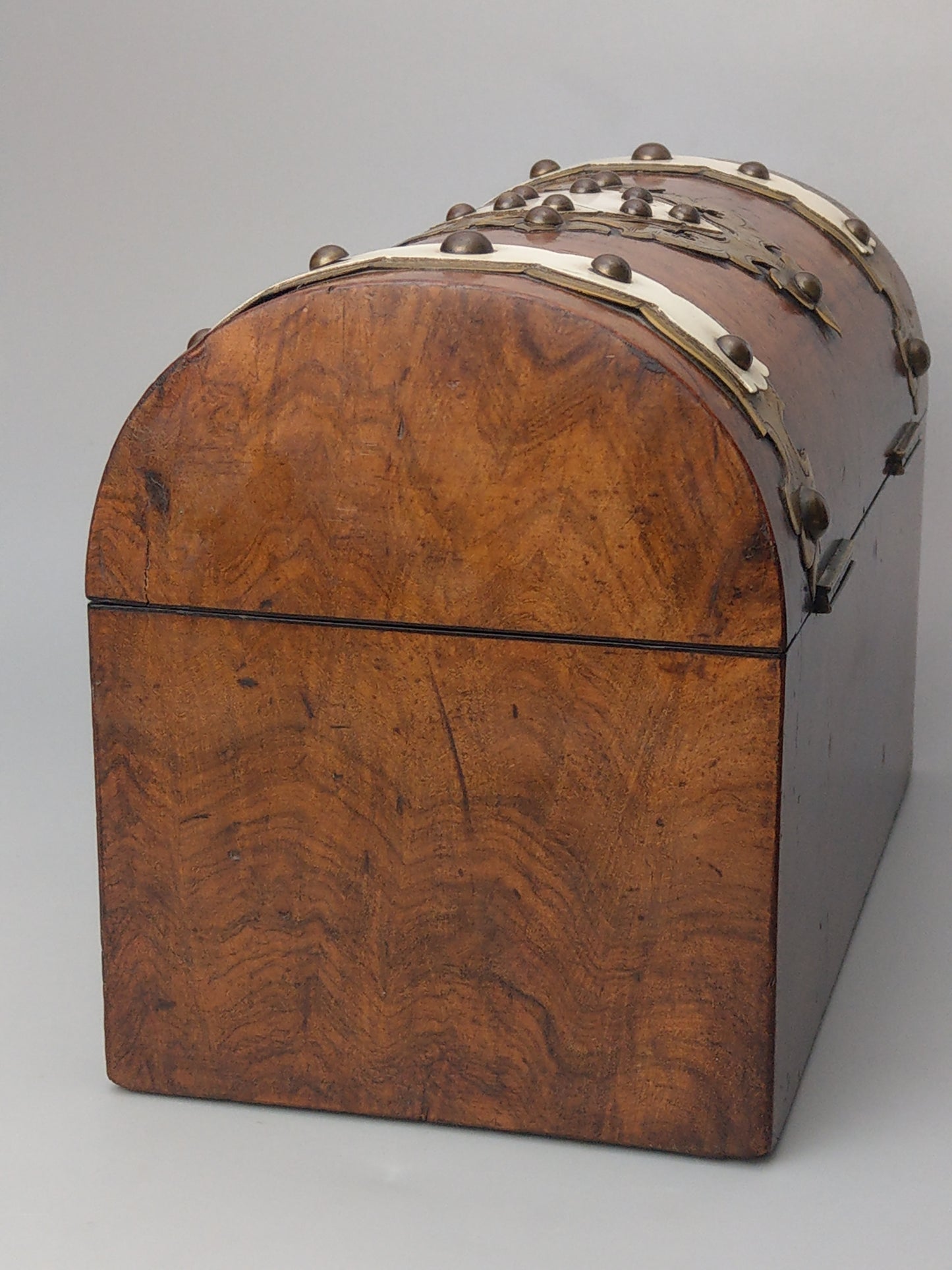 Victorian Burr walnut tea caddy with brass strapwork.