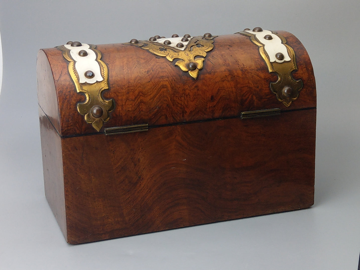 Victorian Burr walnut tea caddy with brass strapwork.