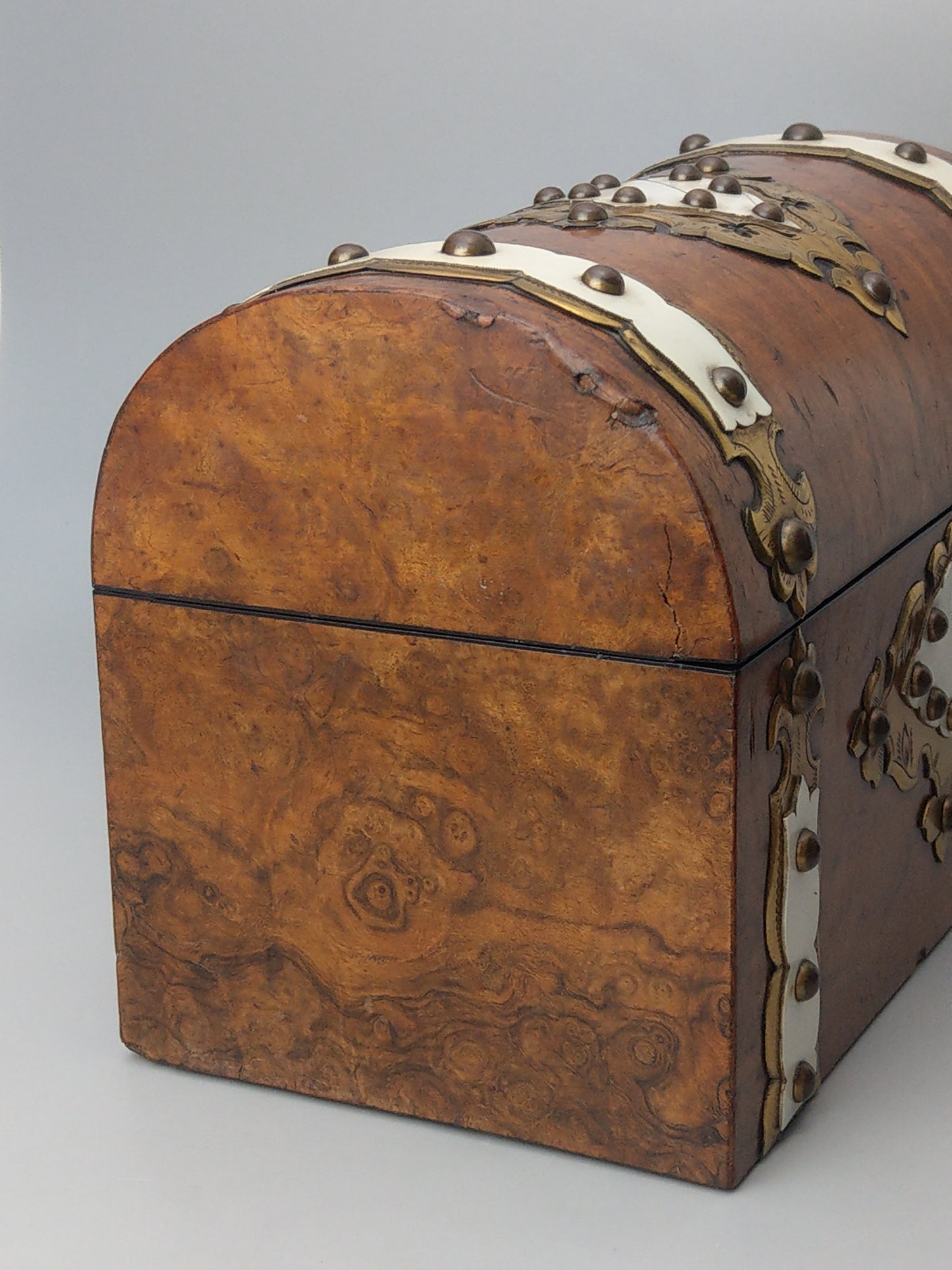 Victorian Burr walnut tea caddy with brass strapwork.