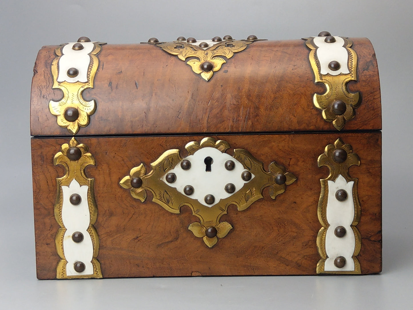 Victorian Burr walnut tea caddy with brass strapwork.