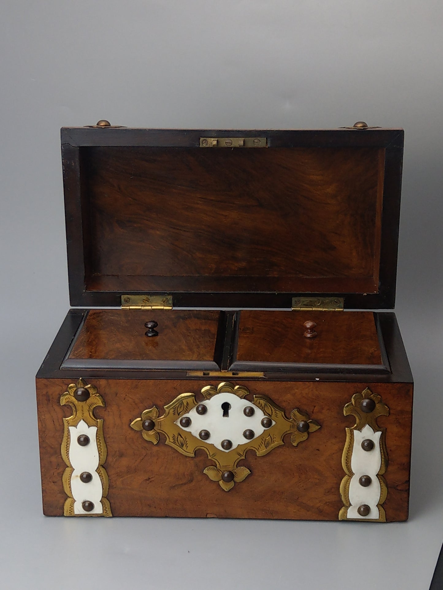 Victorian Burr walnut tea caddy with brass strapwork.