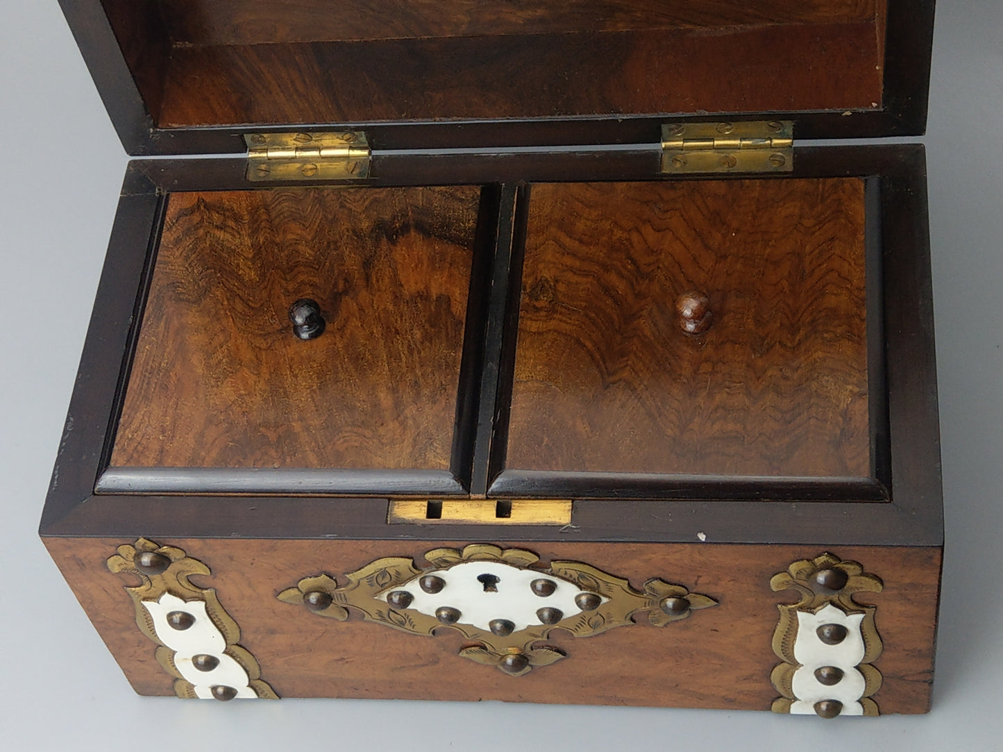 Victorian Burr walnut tea caddy with brass strapwork.