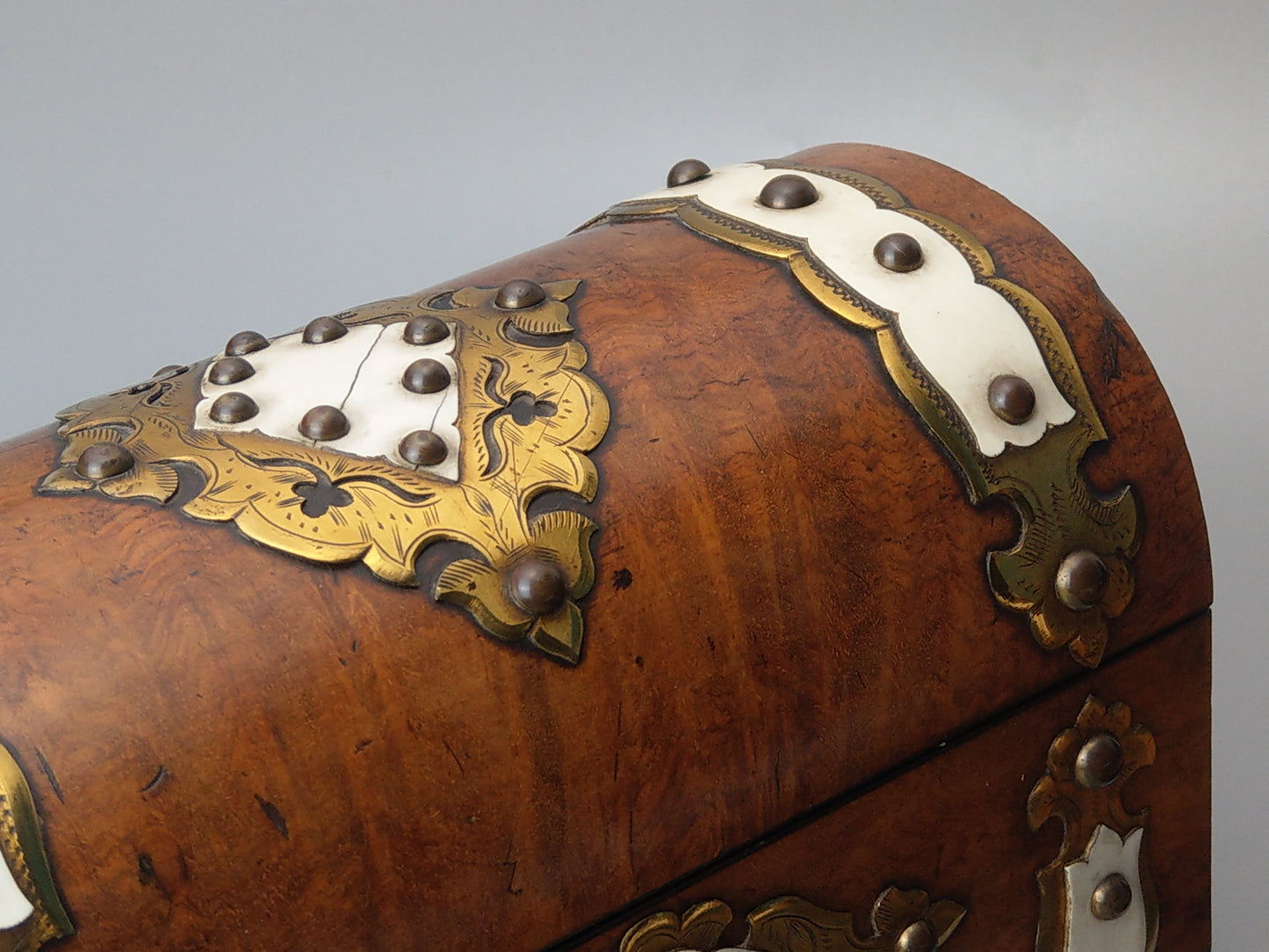 Victorian Burr walnut tea caddy with brass strapwork.