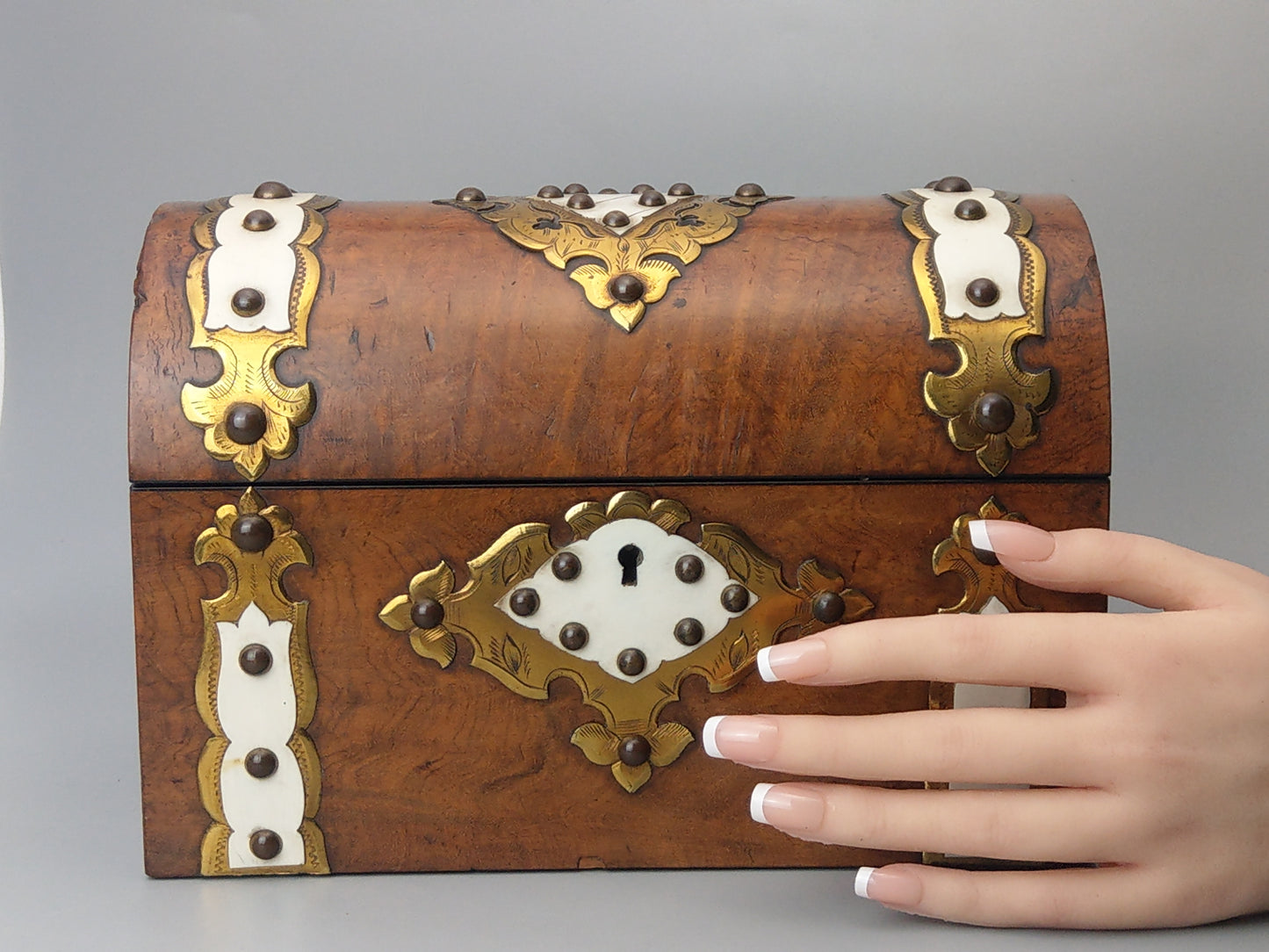 Victorian Burr walnut tea caddy with brass strapwork.